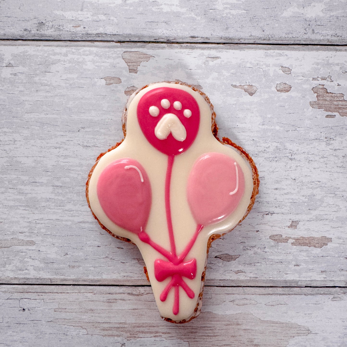 Hand baked dog birthday treats decorated with dog friendly icing.