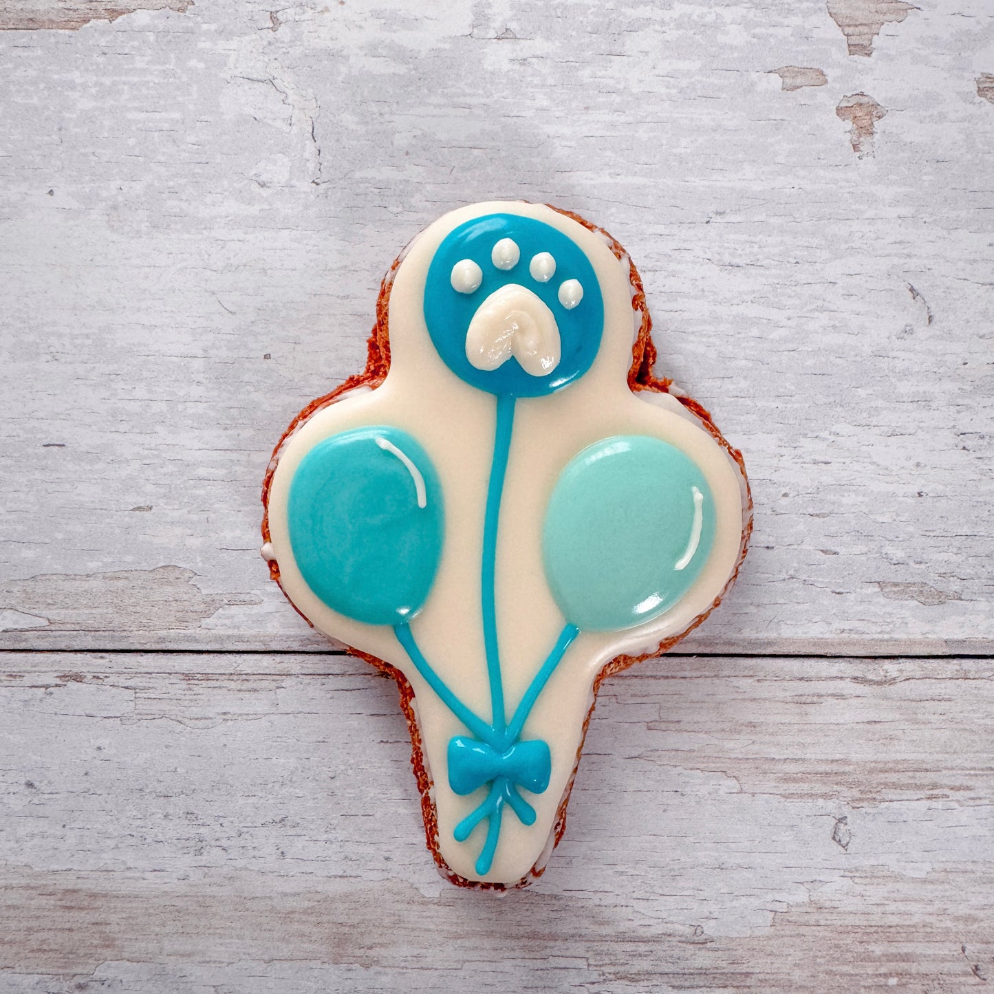 Hand baked dog birthday treats decorated with dog friendly icing.